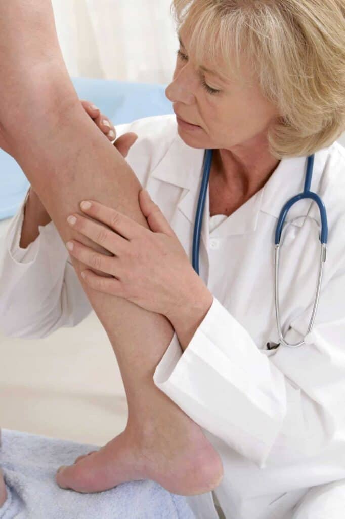 Vein Doctor assessing a patient's calf before laser treatment.